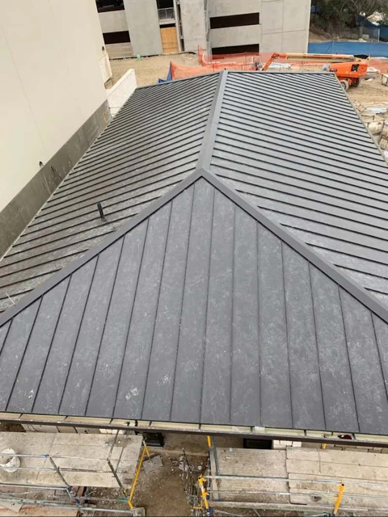 Commercial metal roof construction with crane equipment in Smithfield